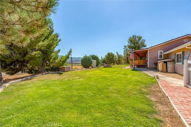 a view of a house with swimming pool and a yard