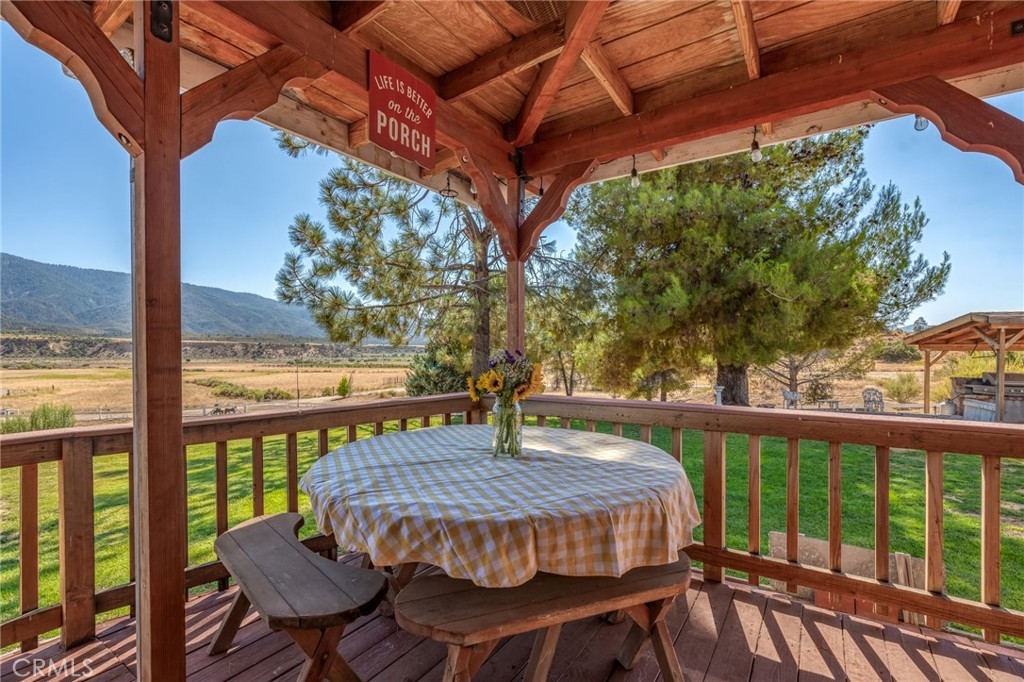 1087 Lockwood Valley Road Maricopa, CA 93252 - Photo 39 of 74 a view of a patio with table and chairs under an umbrella with a small yard