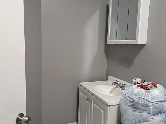 a bedroom with a bed and a flat tv screen on dresser