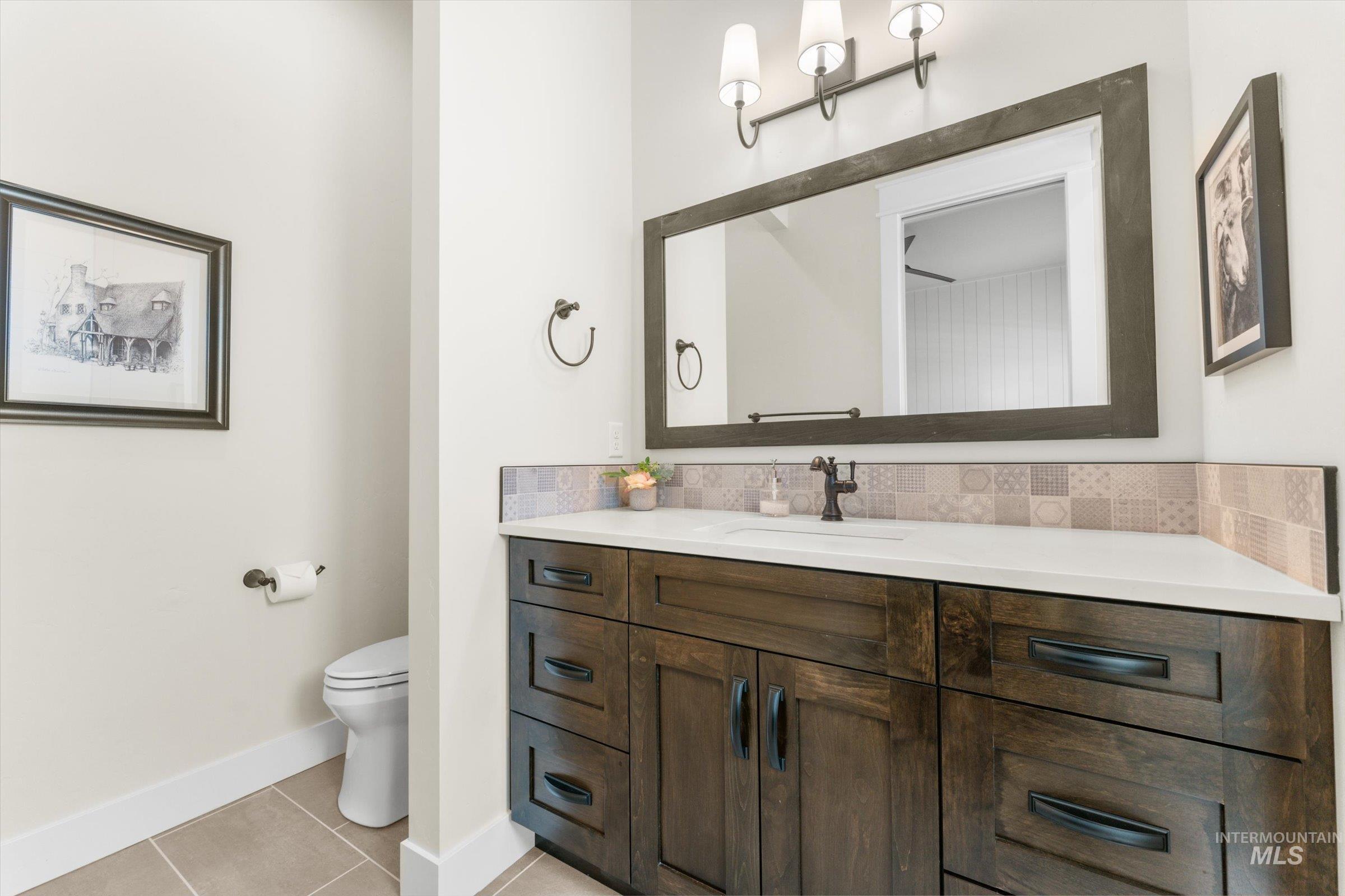 6585 South Pemberley Way Meridian, ID 83642 - Photo 35 of 43 Hardwood vanity with a white countertop and integrated sink