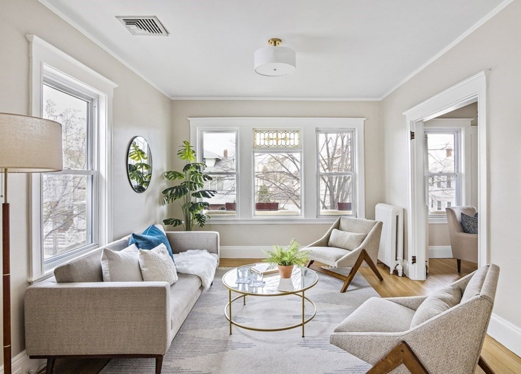 22 Wellington Road Medford, MA 02155 - Photo 1 of 16 a living room with furniture and a large window