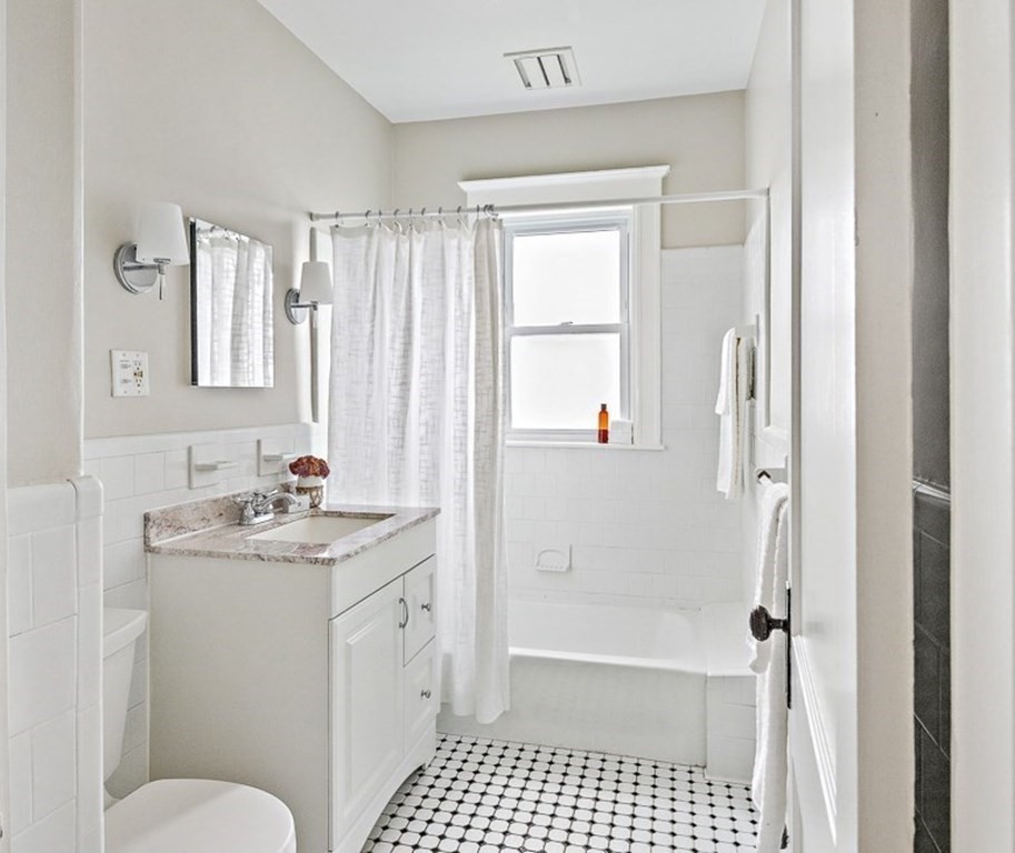 22 Wellington Road Medford, MA 02155 - Photo 12 of 16 a bathroom with a sink a toilet and shower