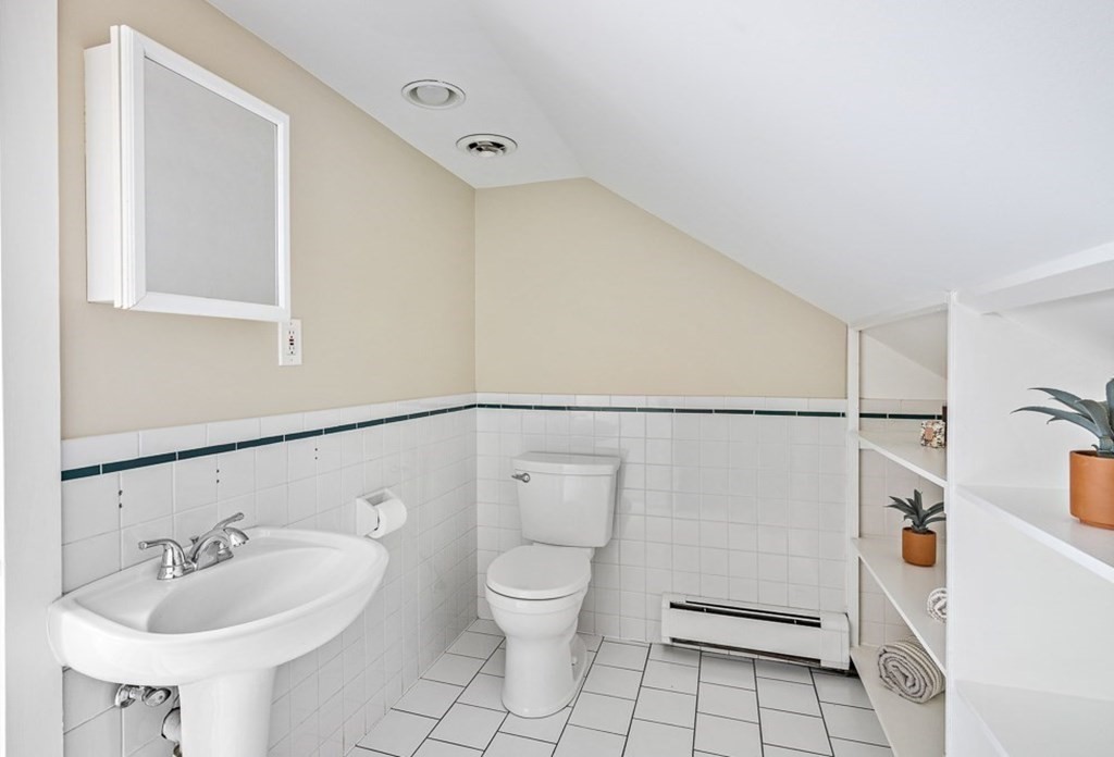 22 Wellington Road Medford, MA 02155 - Photo 13 of 16 a bathroom with a sink mirror vanity and toilet
