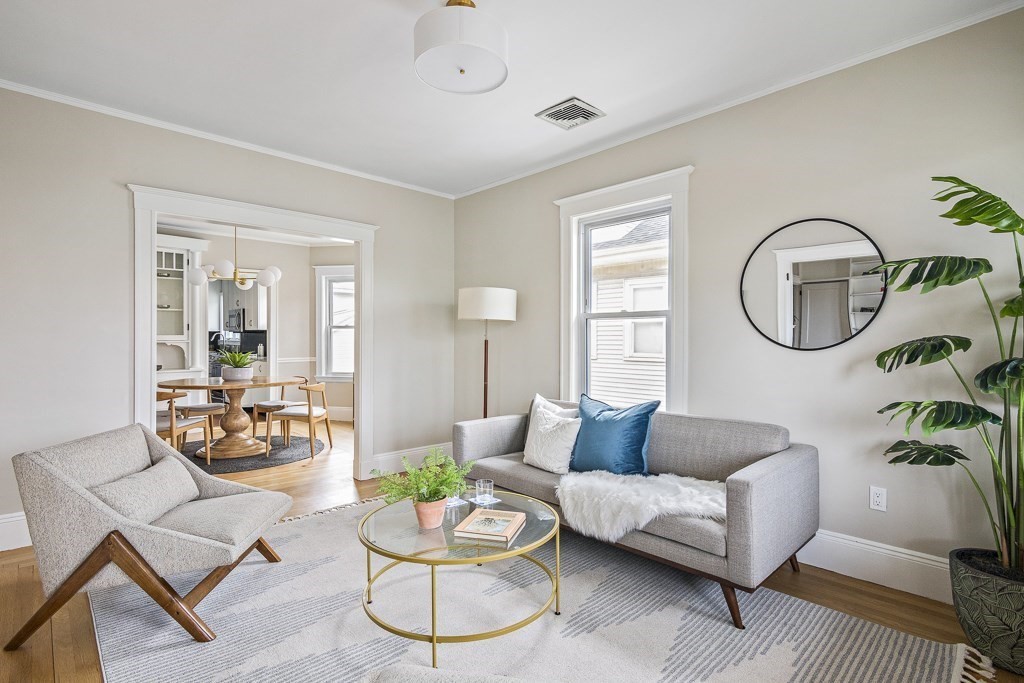 22 Wellington Road Medford, MA 02155 - Photo 2 of 16 a living room with furniture and a large window