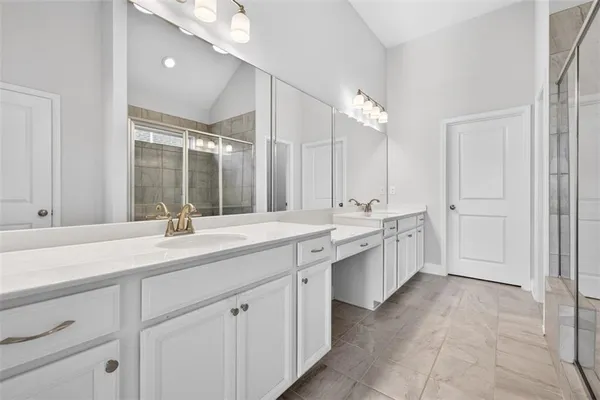 a bathroom with a sink double vanity and a mirror