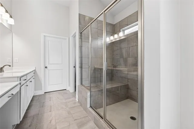 a bathroom with a shower and a sink