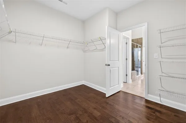 a view of a room with wooden floor