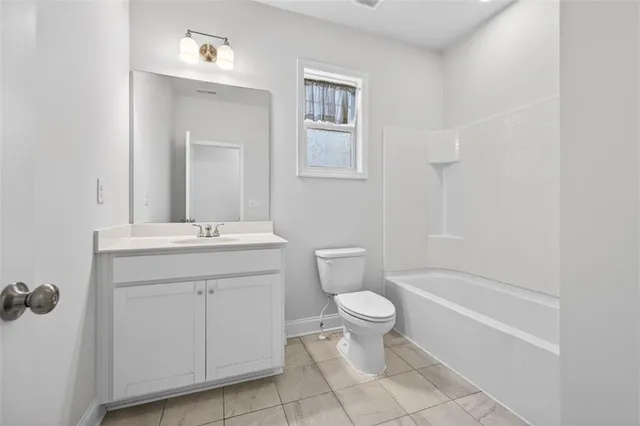 a bathroom with a toilet sink and a bathtub