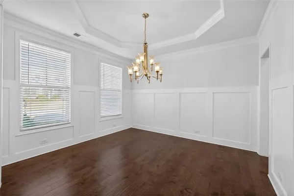 a view of a room with window and hardwood floor