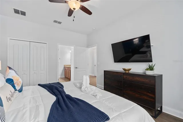 a bedroom with a bed and a flat screen tv