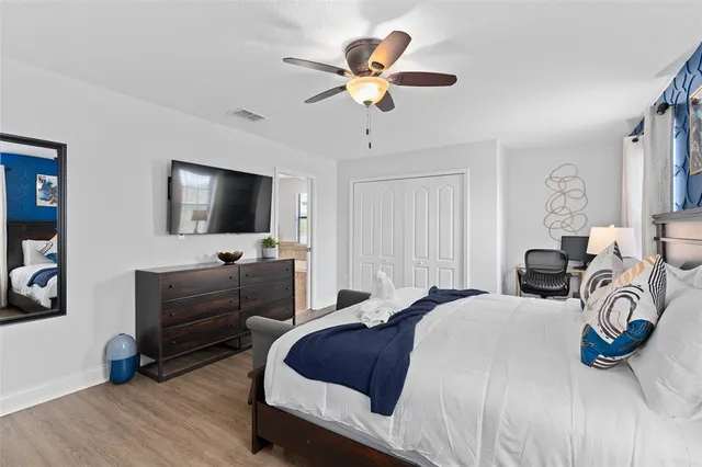 a bedroom with a bed and a flat screen tv