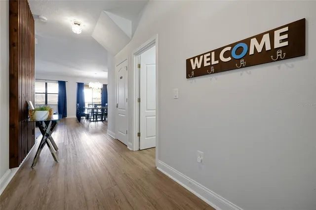 a view of a hallway with wooden floor