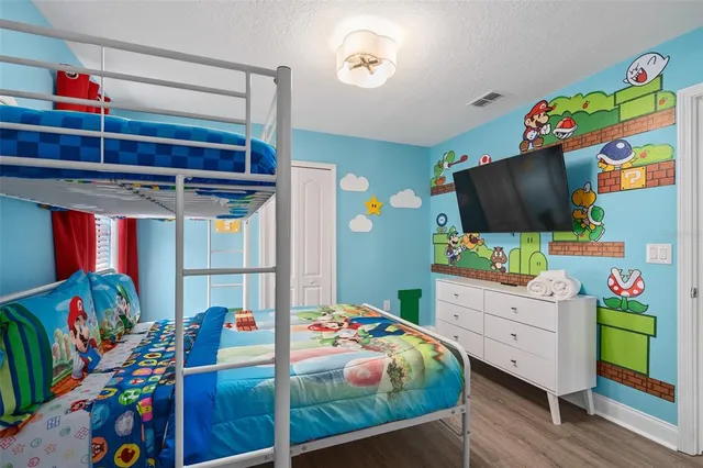 a bedroom with a bed and a chandelier