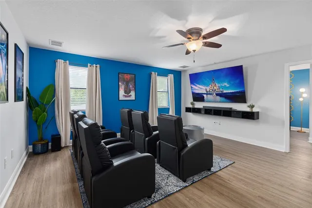 a bedroom with a bed and a flat tv screen on dresser