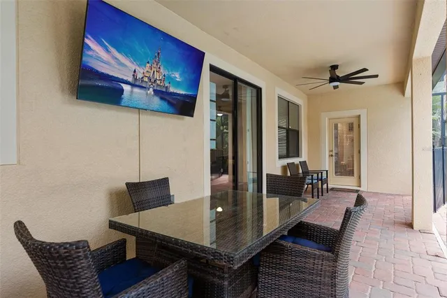 a view of a patio with table and chairs with wooden floor and fence