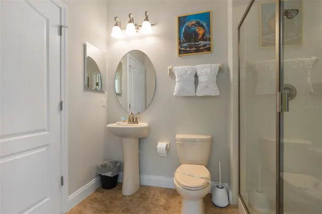 an aerial view of residential houses with outdoor space and parking