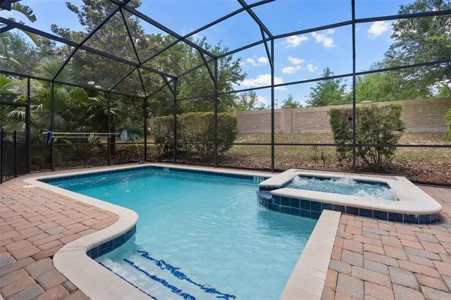 an aerial view of a house with swimming pool and patio