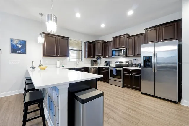 a kitchen with kitchen island a sink appliances and cabinets