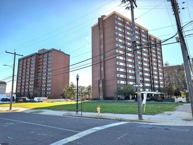 a view of a tall building next to a yard