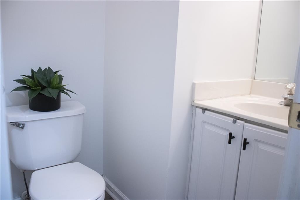 840 Camelon Court Alpharetta, GA 30004 - Photo 11 of 25 a white toilet sitting next to a bathroom sink