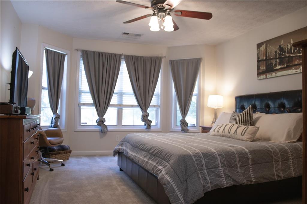 840 Camelon Court Alpharetta, GA 30004 - Photo 12 of 25 a bedroom with a bed and a large window