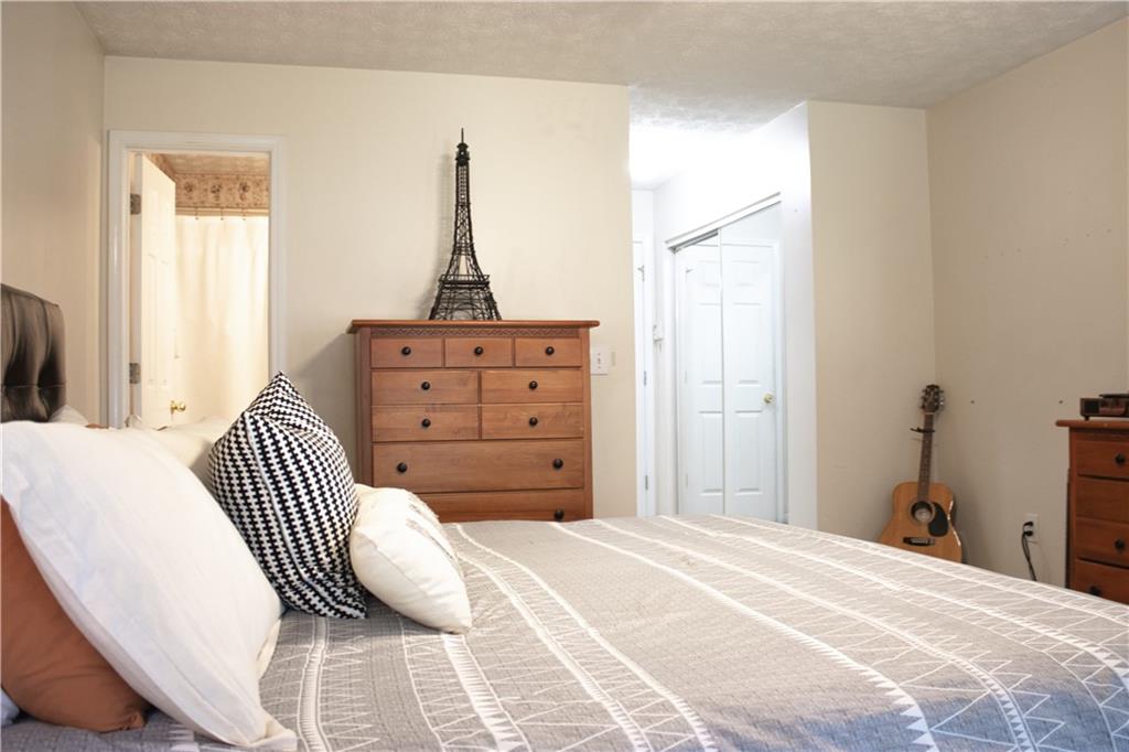 840 Camelon Court Alpharetta, GA 30004 - Photo 13 of 25 a bedroom with a bed and a window