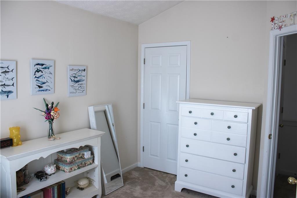 840 Camelon Court Alpharetta, GA 30004 - Photo 18 of 25 a bedroom with a bed and a dresser