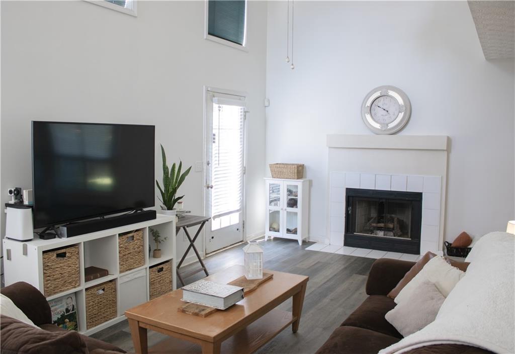840 Camelon Court Alpharetta, GA 30004 - Photo 5 of 25 a living room with furniture a flat screen tv and a fireplace