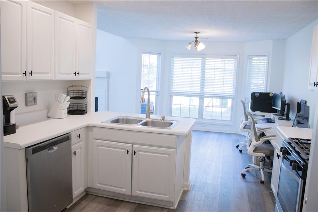 840 Camelon Court Alpharetta, GA 30004 - Photo 10 of 25 a kitchen with sink cabinets and wooden floor