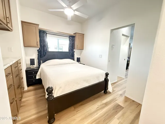 a bedroom with a bed dresser and a window