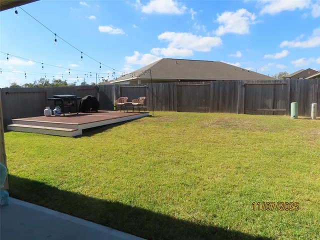 a view of a house with backyard and sitting area