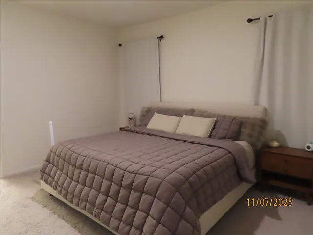 a bedroom with a bed and a night stand