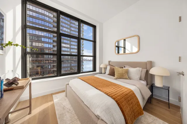 a bathroom with a sink mirror and shower