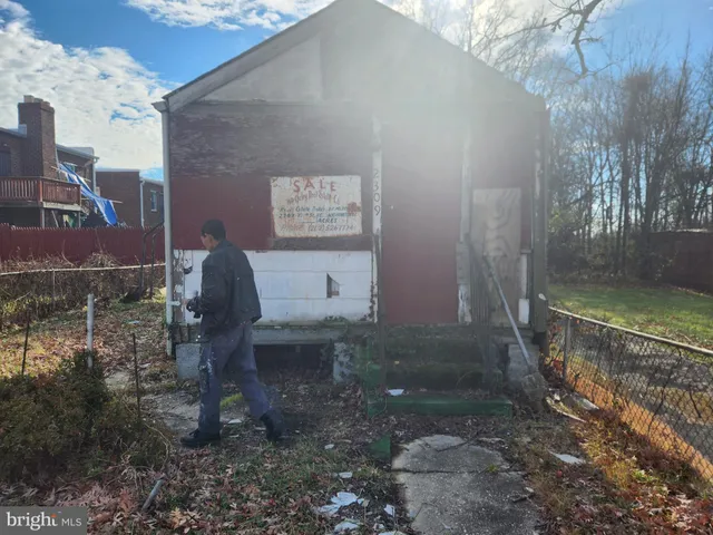a backyard of a house with fountain table and chairs