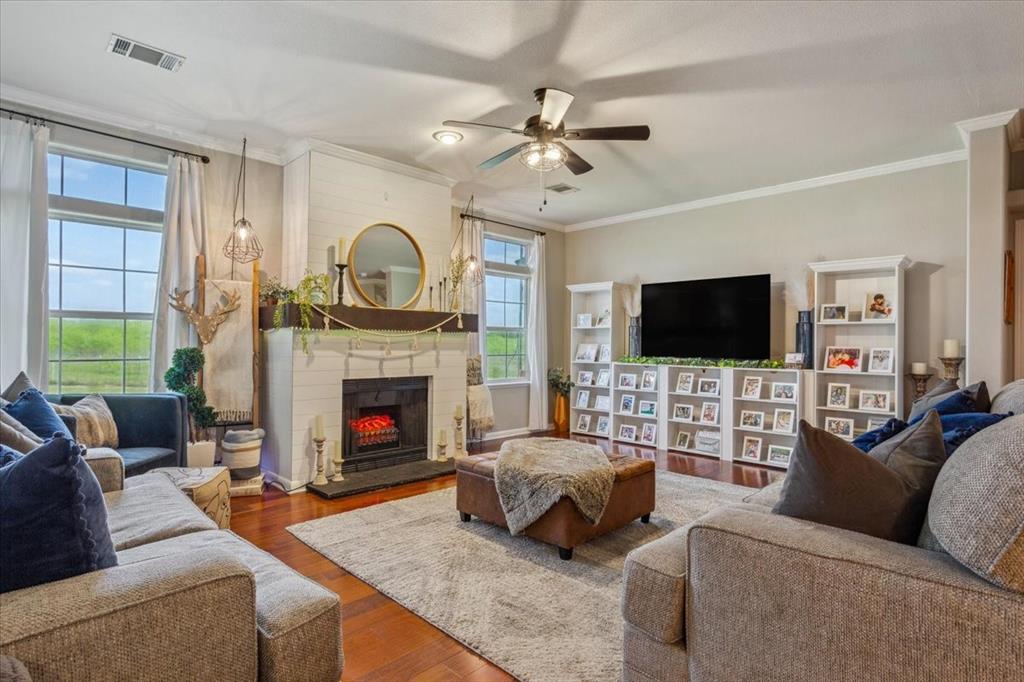 3356 Kattner Road Riesel, TX 76682 - Photo 12 of 40 Living area featuring plenty of natural light, visible vents, a fireplace, and ceiling fan