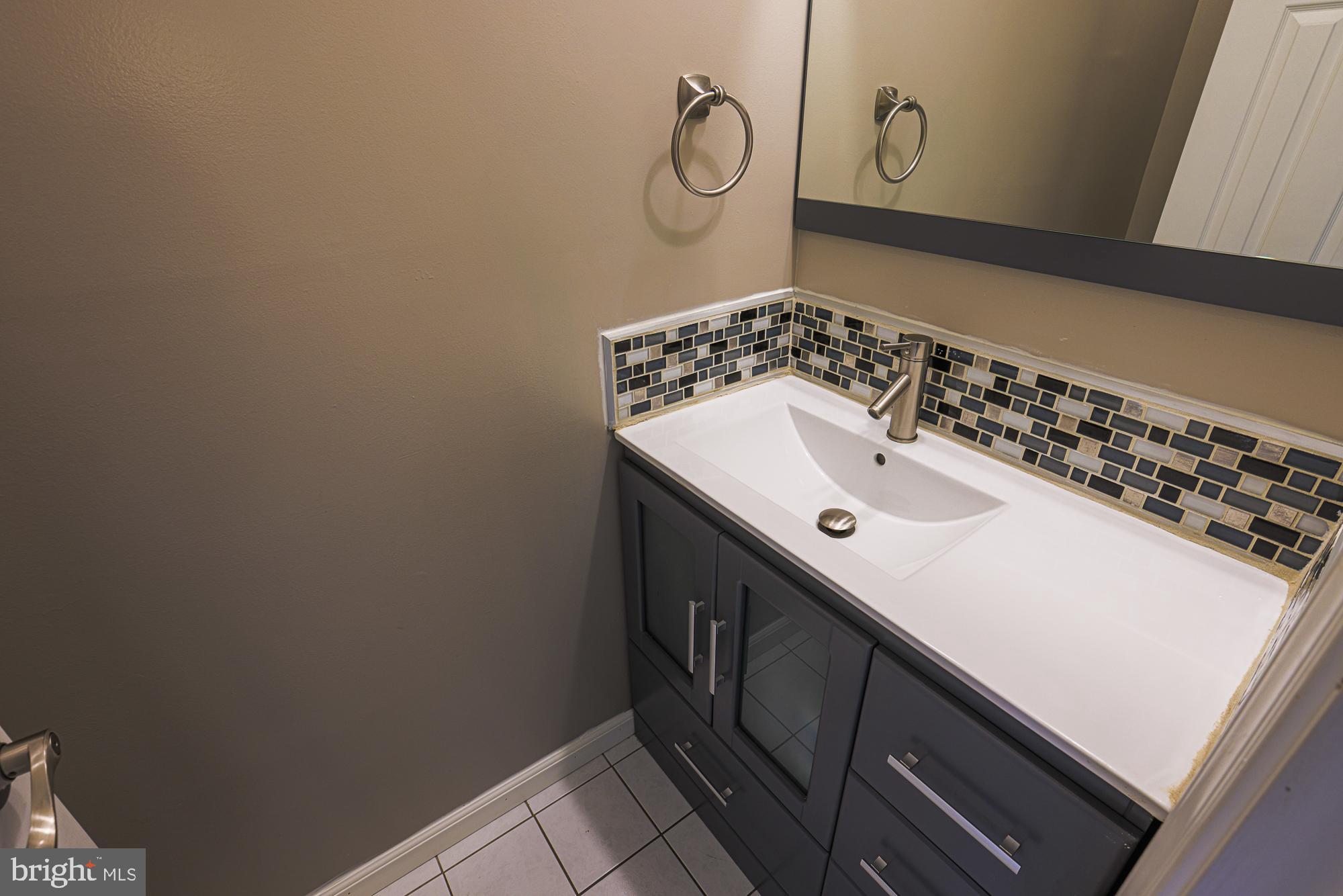 4402 Macworth Place Nottingham, MD 21236 - Photo 17 of 36 a bathroom with a sink and a mirror