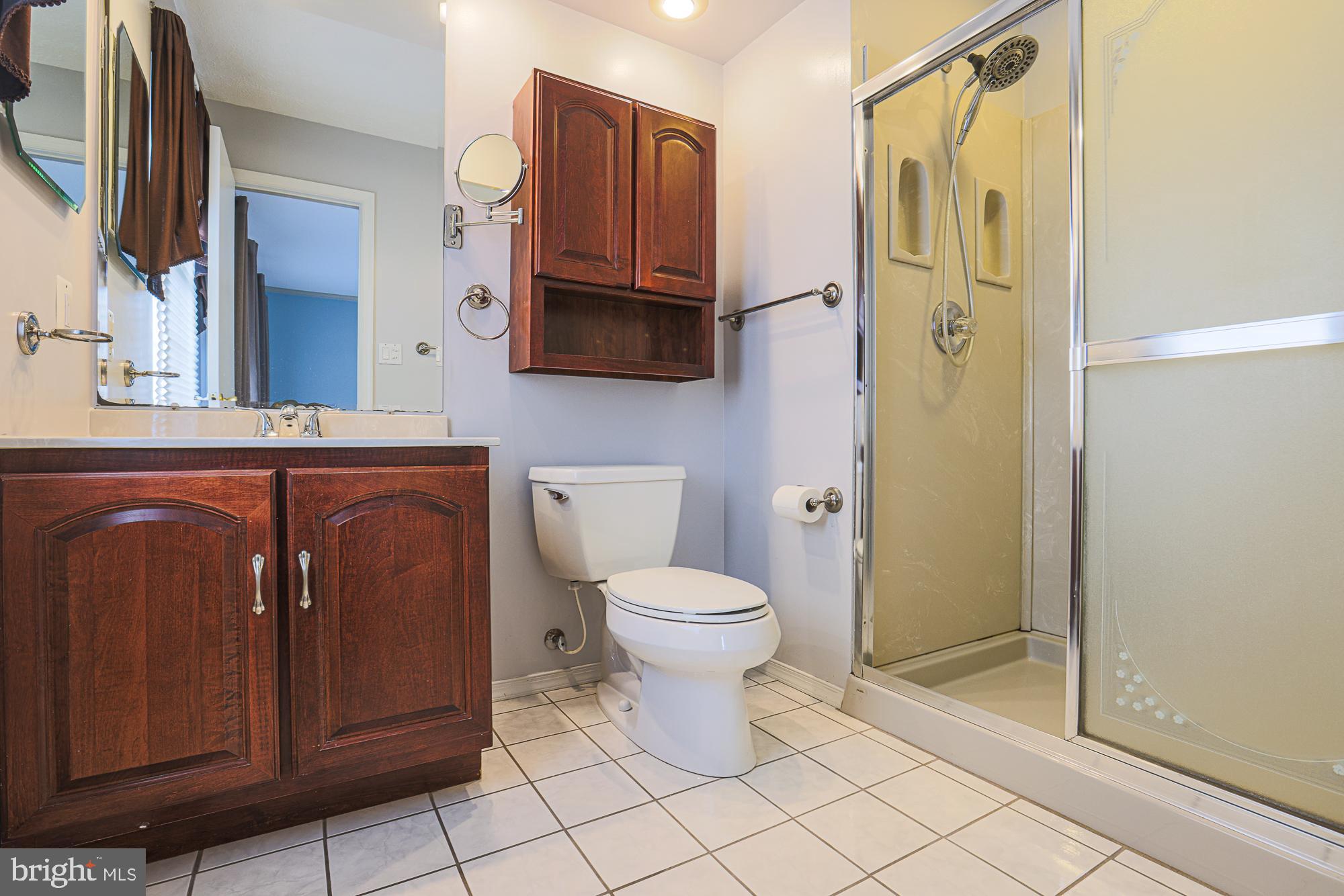 4402 Macworth Place Nottingham, MD 21236 - Photo 22 of 36 a bathroom with a toilet sink and mirror