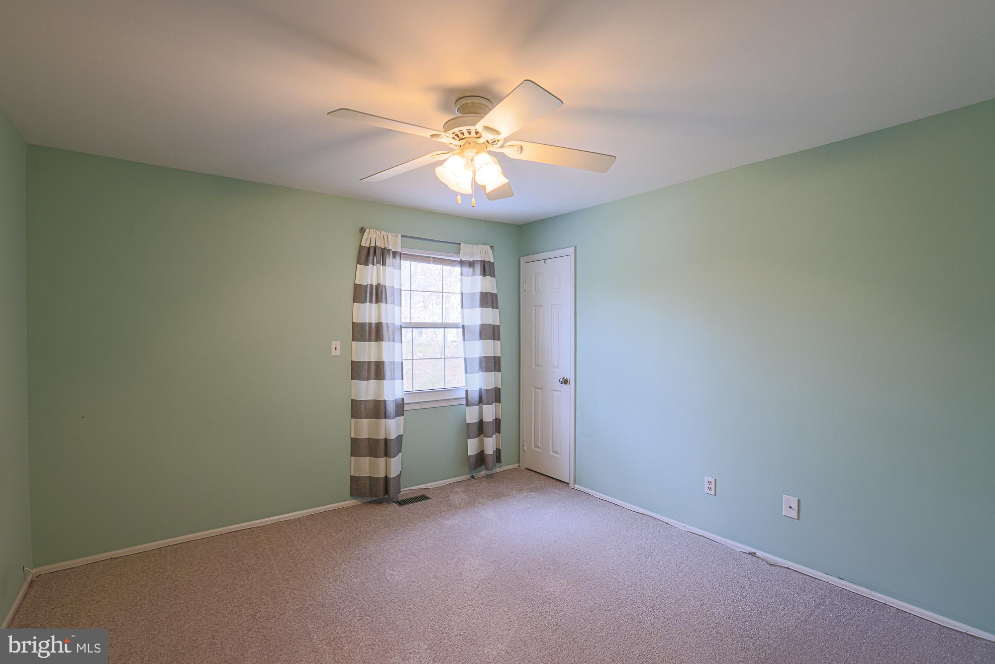 4402 Macworth Place Nottingham, MD 21236 - Photo 23 of 36 an empty room with windows and fan