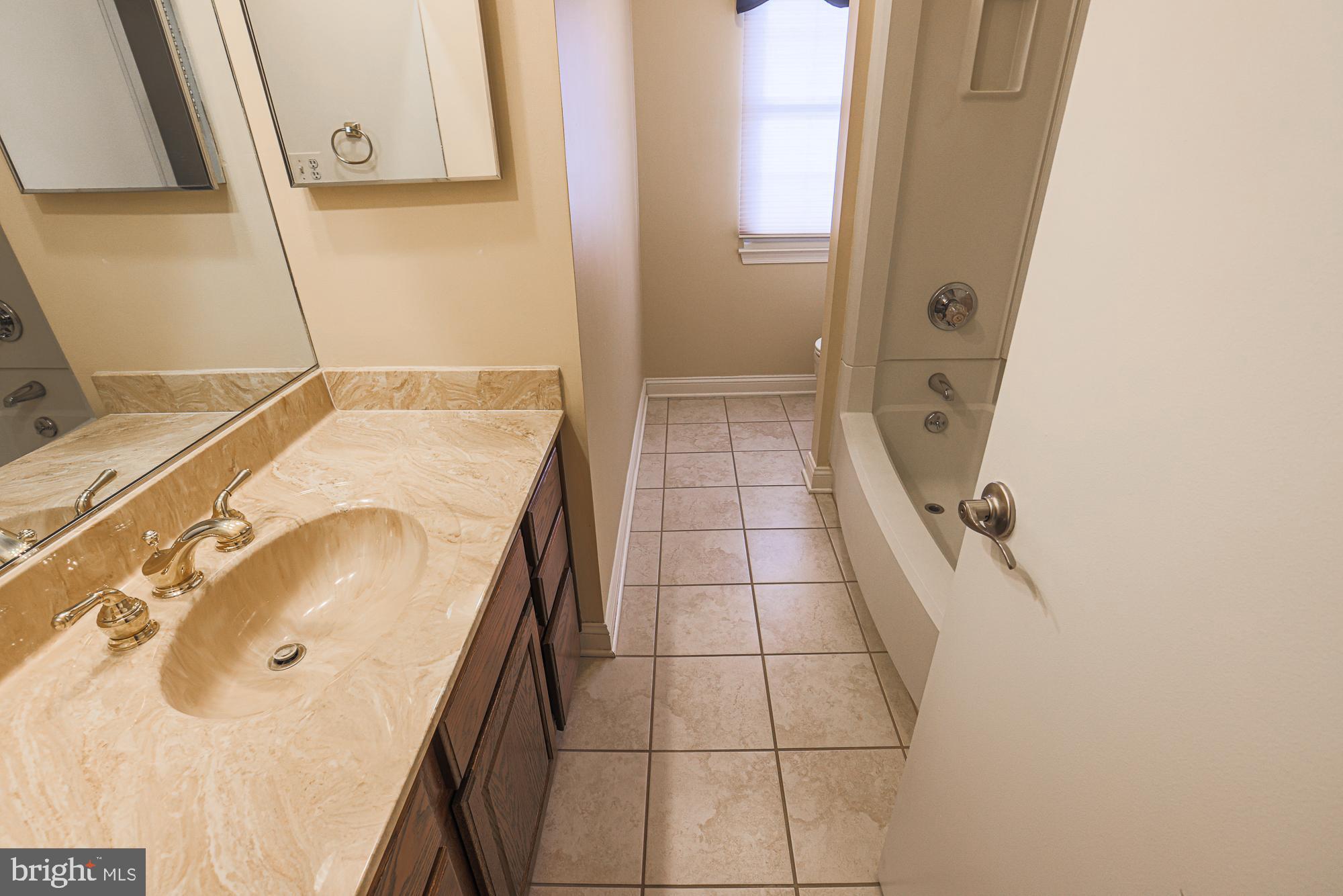 4402 Macworth Place Nottingham, MD 21236 - Photo 25 of 36 a bathroom with a sink and a mirror