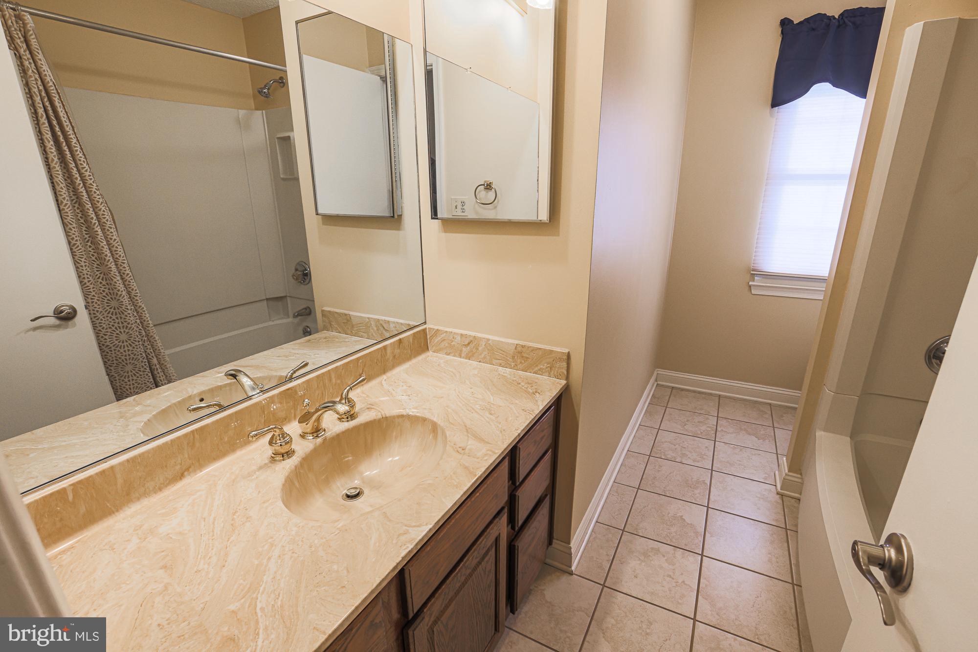 4402 Macworth Place Nottingham, MD 21236 - Photo 26 of 36 a bathroom with a sink and a mirror