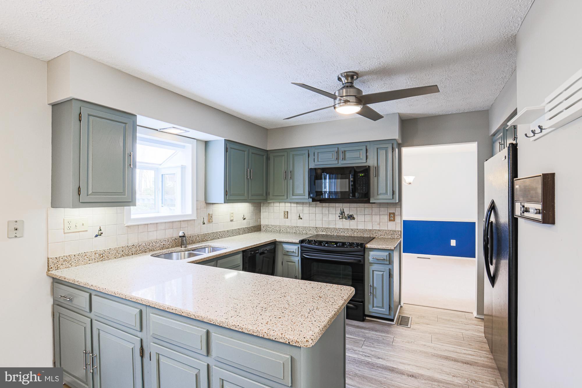 4402 Macworth Place Nottingham, MD 21236 - Photo 10 of 36 a kitchen with a sink a stove and microwave