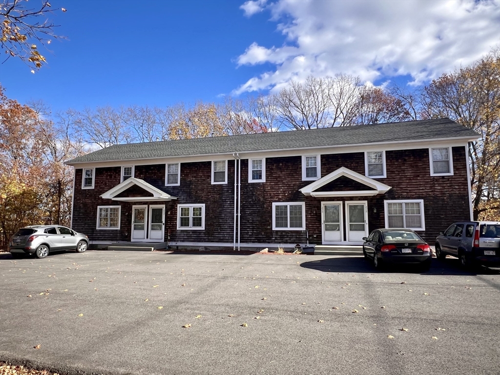 230 Beacon Street, Unit 3 Clinton, MA 01510 - Photo 1 of 13 a front view of a residential apartment building with a yard