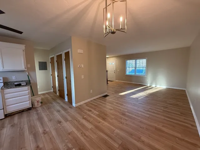 a view of livingroom with hardwood floor and kitchen view