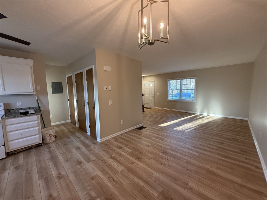 230 Beacon Street, Unit 3 Clinton, MA 01510 - Photo 5 of 13 a view of livingroom with hardwood floor and kitchen view