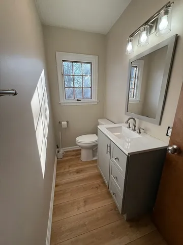 a spacious bathroom with a sink a toilet and a mirror