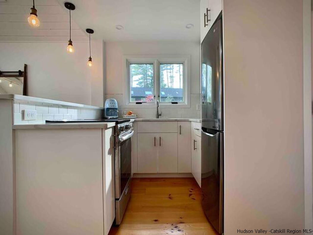 172 Crystal Point Road Cairo, NY 12431 - Photo 24 of 35 a kitchen with a sink stove and refrigerator