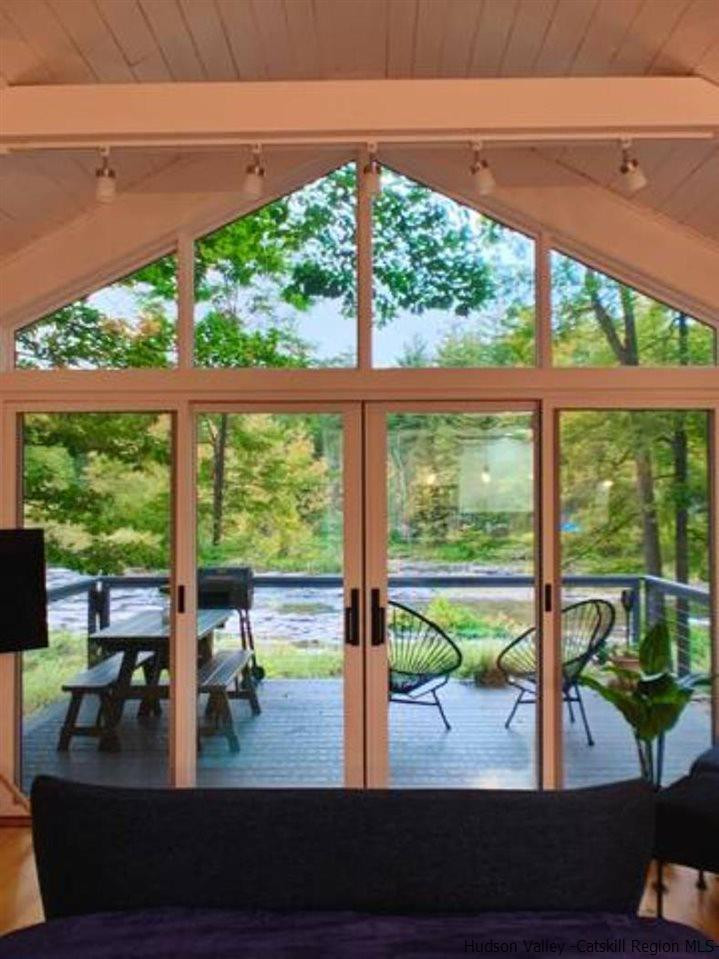 172 Crystal Point Road Cairo, NY 12431 - Photo 26 of 35 a view of a room with wooden floor and a floor to ceiling window
