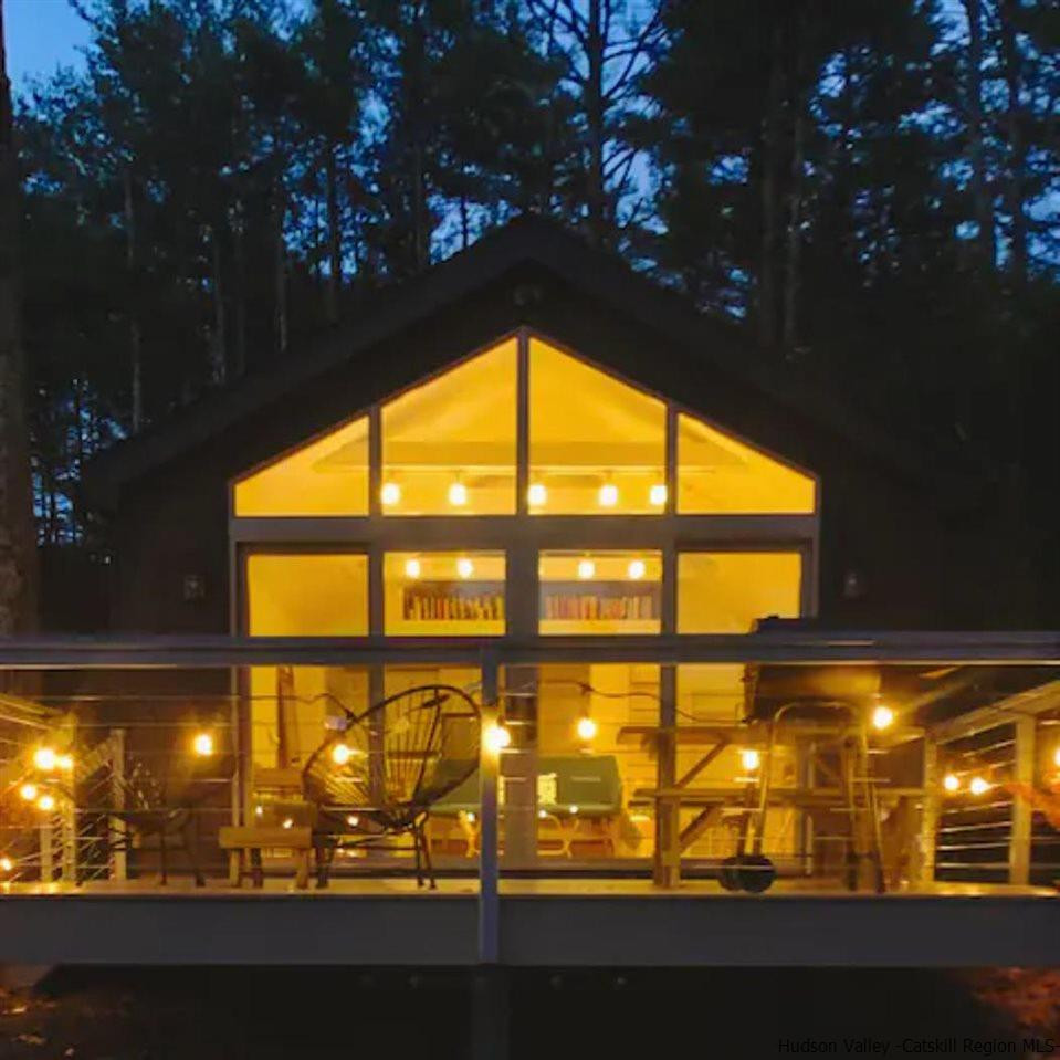 172 Crystal Point Road Cairo, NY 12431 - Photo 5 of 35 a view of an empty room with a floor to ceiling window and tree