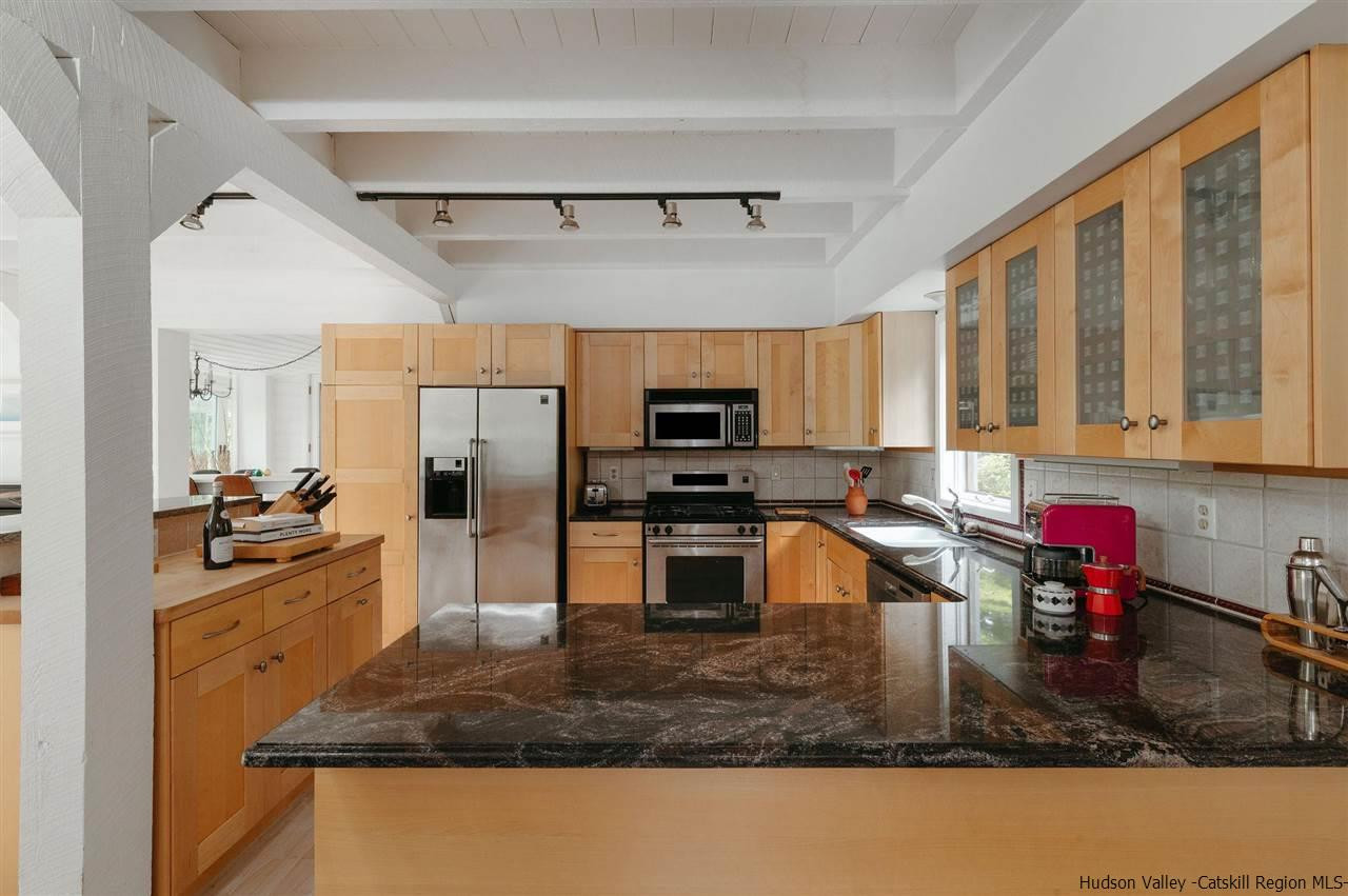 172 Crystal Point Road Cairo, NY 12431 - Photo 6 of 35 a kitchen with a stove a sink and a microwave