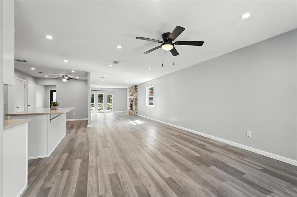 1402 Country Lane Allen, TX 75002 - Photo 11 of 39 Unfurnished living room with recessed lighting, french doors, light wood-style floors, and ceiling fan